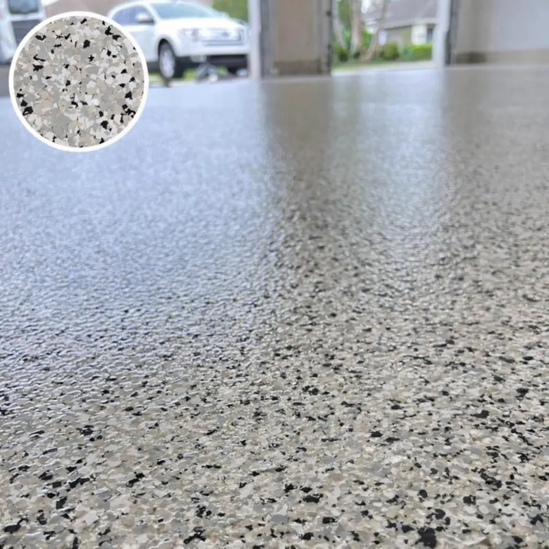 Gros plan d'un sol résine pailletée beige, gris et noir